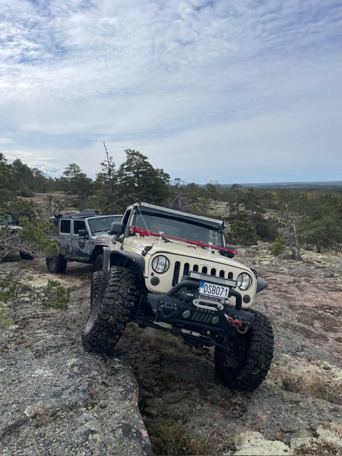 Off-road vehicles travelling together on a mountain trail