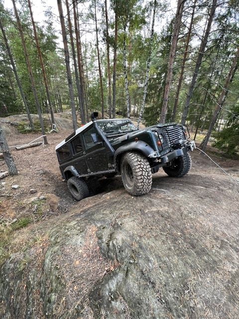 Off-road vehicle climbing a rocky trail